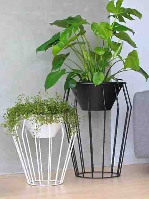 Wrought-iron plant stand holding a planted pot
